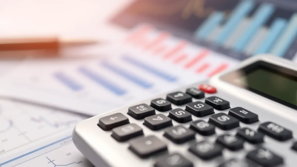 Generic image of a calculator and economic charts, symbolizing labor data analysis.
