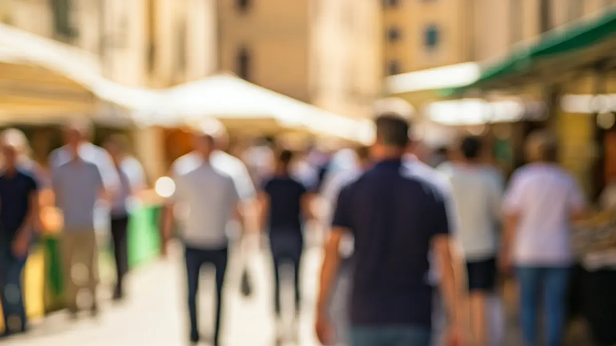 Generic image of a weekly market with stalls and people shopping.