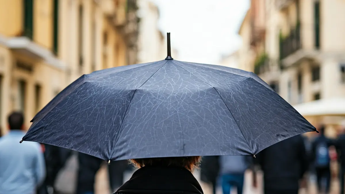 Image of a promotional umbrella with an abstract design on a Mediterranean city street.