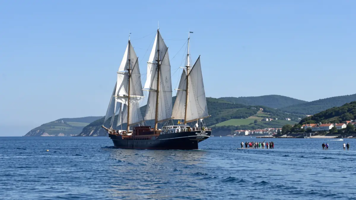 Image of a ship with four automated sails navigating at sea.