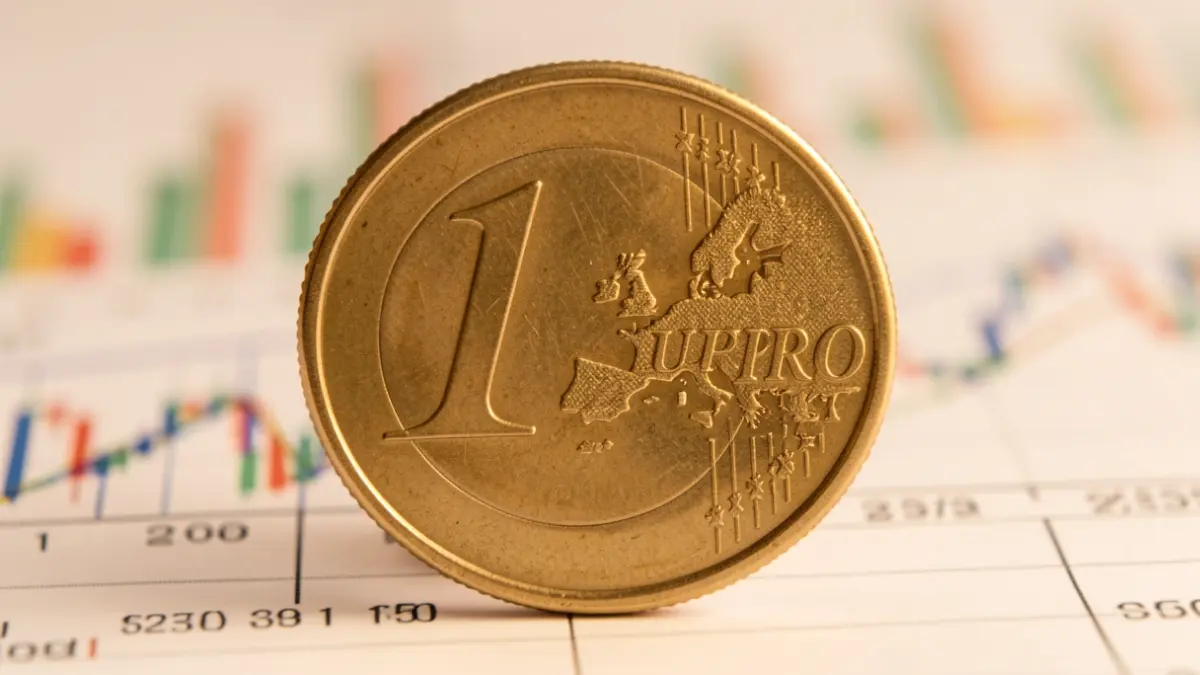 Close-up of a euro coin with an upward arrow over financial charts.