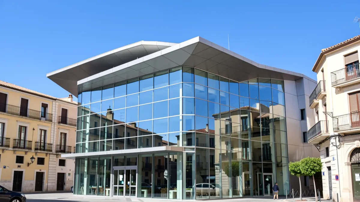 Generic facade of a modern convention center under a blue sky.
