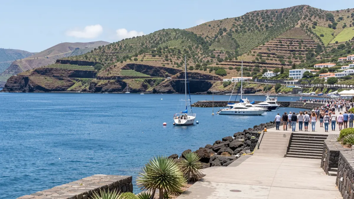 View of Puerto de Vueltas in La Gomera, with calm waters and green hills.